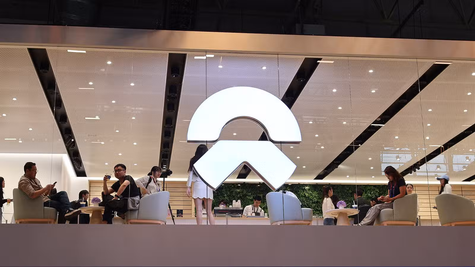 Nio seeks Hong Kong primary listing to open door to Stock Connect The Nio logo at its booth at the Beijing Auto Show in April 2026.