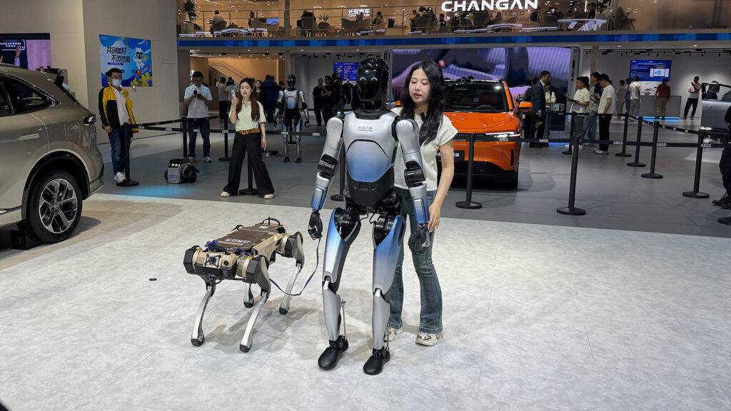 A humanoid robot and a robot dog on display at the Changan booth at the Shanghai Auto Show in April 2025.