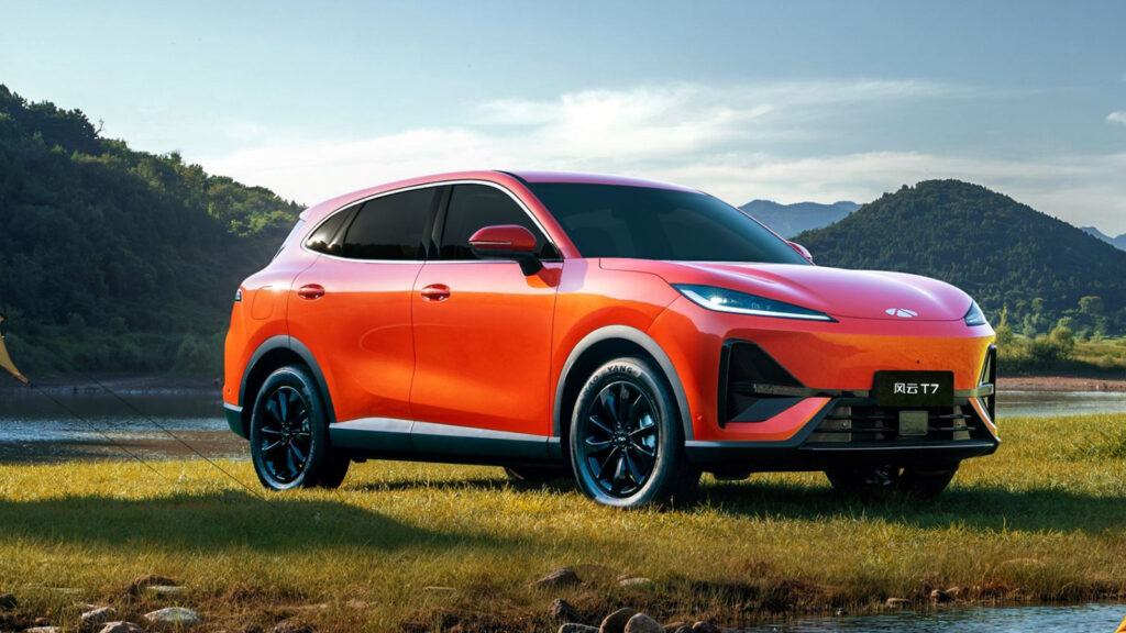 Chery launches Fulwin T7 electric SUV with 600 km range from under $15,000 Orange Chery Fulwin T7 electric SUV parked beside a lake, shown from a front three-quarter angle.
