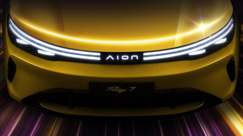 Front view of the GAC Aion Ray 7 in an official teaser image, highlighting its full-width lighting signature and illuminated Aion logo.