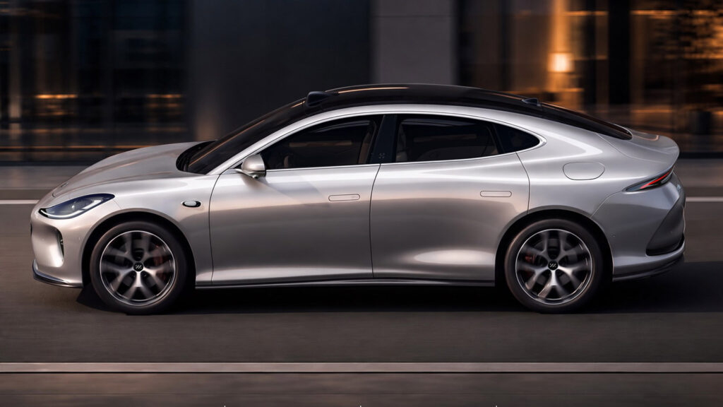 Side view of the all-new silver IM L6 electric sedan driving at night.
