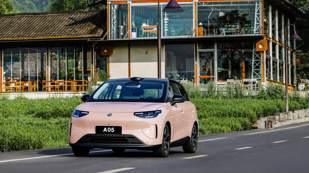 Leapmotor A05 driving on a road in a scenic outdoor setting.