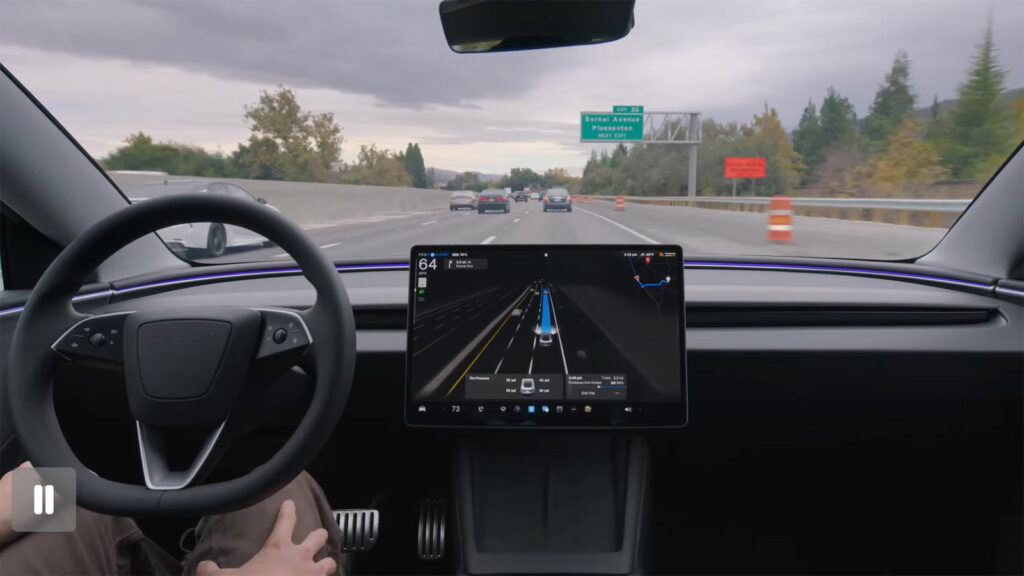 A Tesla using FSD Supervised on a highway, with the center touchscreen displaying driving visualization and navigation information.