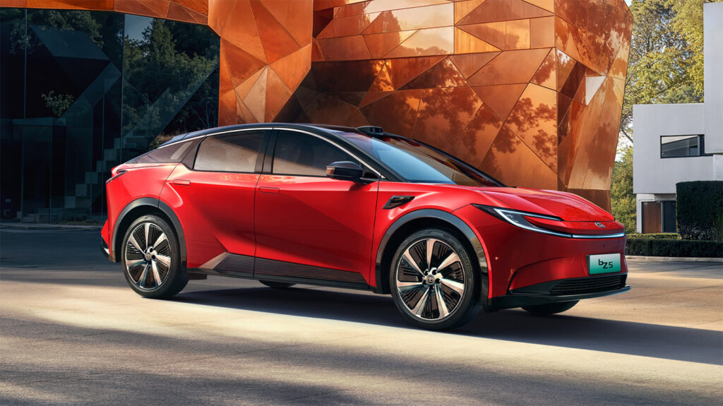 Toyota launches refreshed bZ5, betting on stronger driver assistance to retain Chinese buyers Red 2027 Toyota bZ5 electric coupe SUV parked outside a modern copper-clad building.