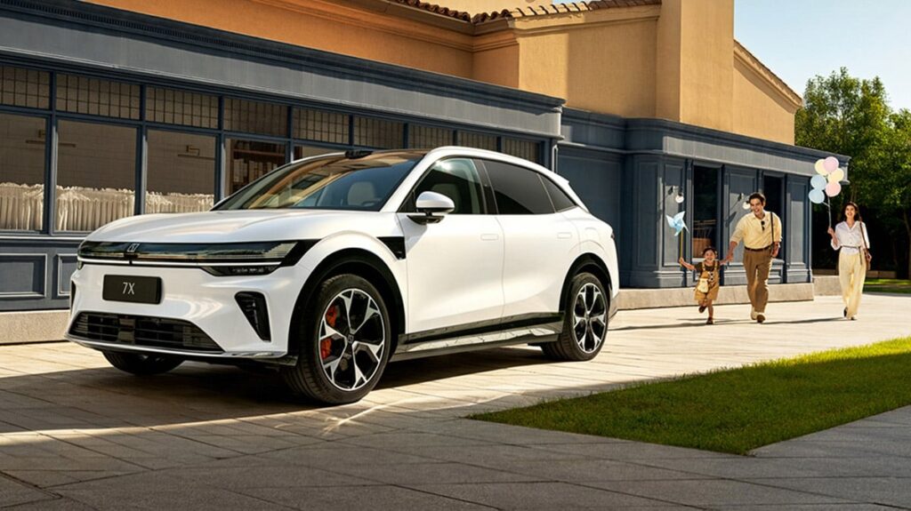 Zeekr 7X orders top 200,000 globally A white Zeekr 7X electric SUV parked outside a house as a family approaches in the background.
