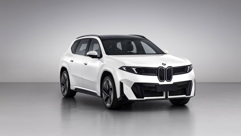 Front three-quarter view of a white BMW Neue Klasse iX3 30L electric SUV with a black roof and twin kidney grille.