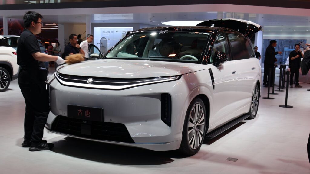 White BYD Da Tang EV with a black roof displayed at the Beijing Auto Show in April 2026, viewed from the front quarter.