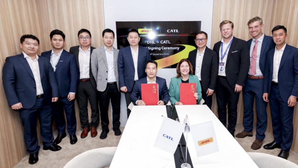 CATL, DHL sign new pact to advance road freight electrification in Europe CATL and DHL representatives pose with red agreement folders at a signing ceremony in Hanover, Germany.