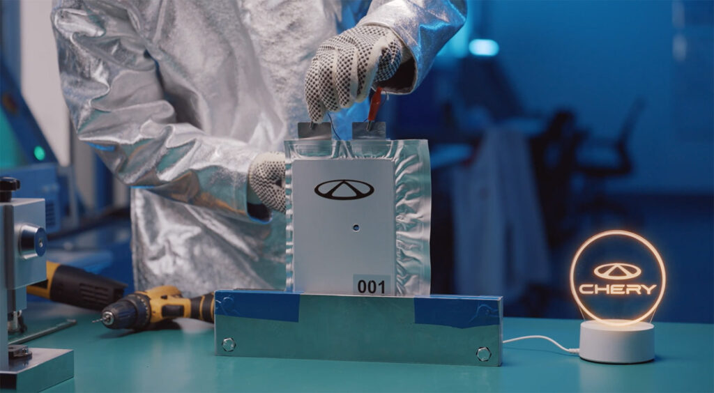A technician tests a Chery solid-state battery cell that continues to supply power after being punctured.