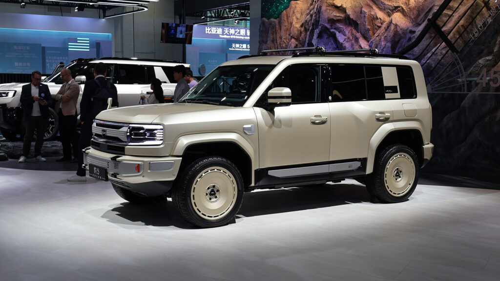 China NEV retail sales fall 3% in first week of September as penetration reaches 71.5% Beige BYD Fang Cheng Bao Bao 5 SUV with a roof rack on display at the 2026 Beijing Auto Show, viewed from the front three-quarter angle.