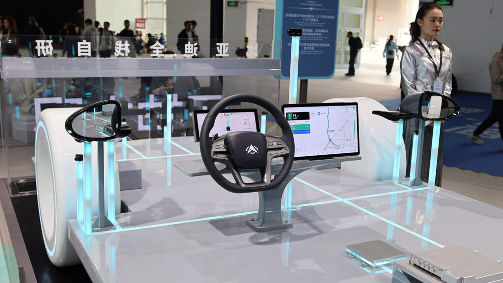 China unveils five-year NEV plan, targets 70% share of passenger-car sales by 2030 BYD autonomous driving prototype with an exposed steering wheel, digital displays and sensors at the 2026 Beijing Auto Show.