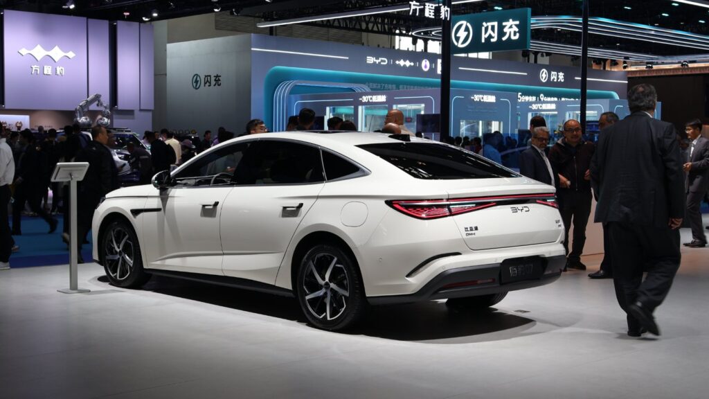 Rear three-quarter view of a white BYD Seal 07 DM-i plug-in hybrid sedan at the 2026 Beijing Auto Show.