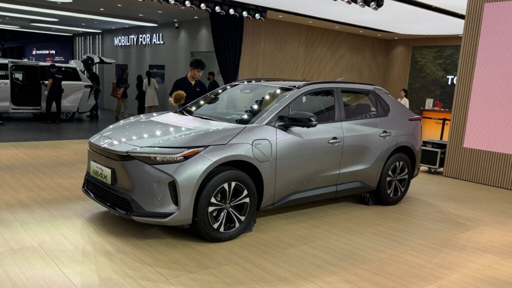 Silver GAC Toyota bZ4X electric SUV displayed at the Shanghai Auto Show in April 2025, viewed from the front and side.