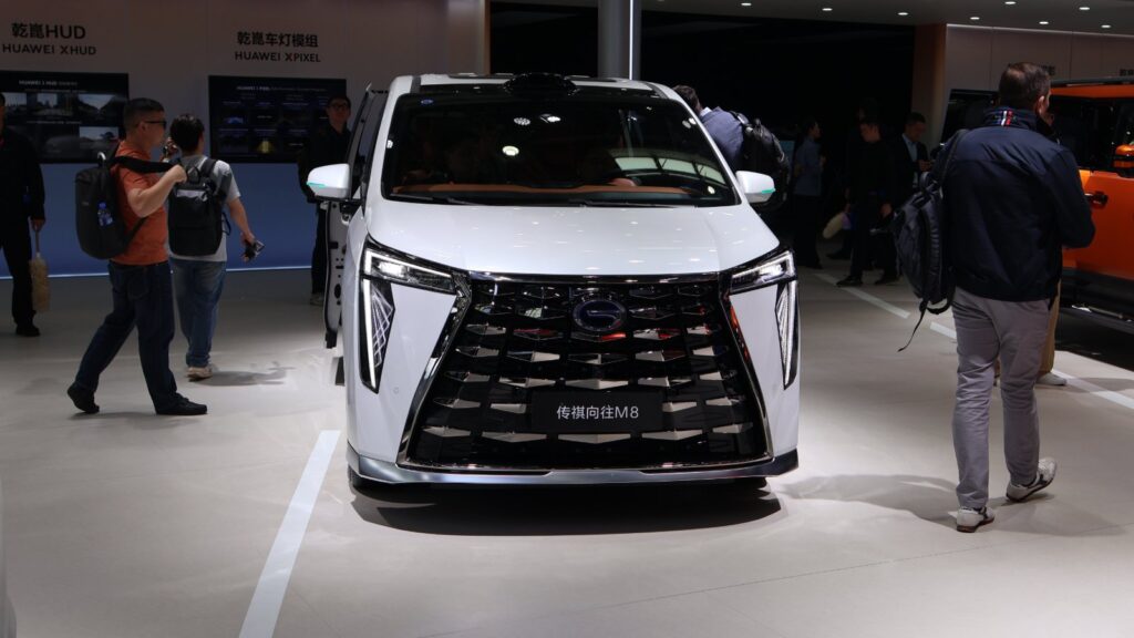 Front view of a white GAC Trumpchi M8 MPV with a large black grille at the 2026 Beijing Auto Show.