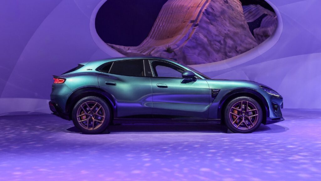 Huawei-backed Luxeed adds smaller-battery version of RX, lowering entry pre-sales price Side profile of a Luxeed RX coupe SUV in an iridescent green-to-purple paint finish with bronze multi-spoke wheels, displayed on a purple-lit stage in front of a large circular backdrop at the Chengdu auto show.