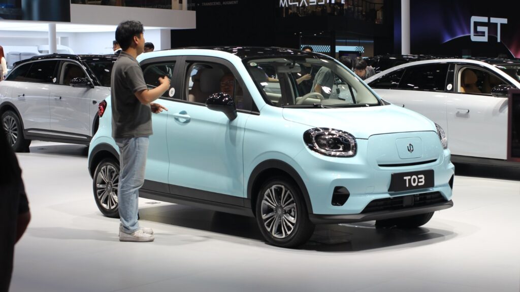 Light blue Leapmotor T03 electric hatchback with a black roof on display at the 2025 Shanghai Auto Show.