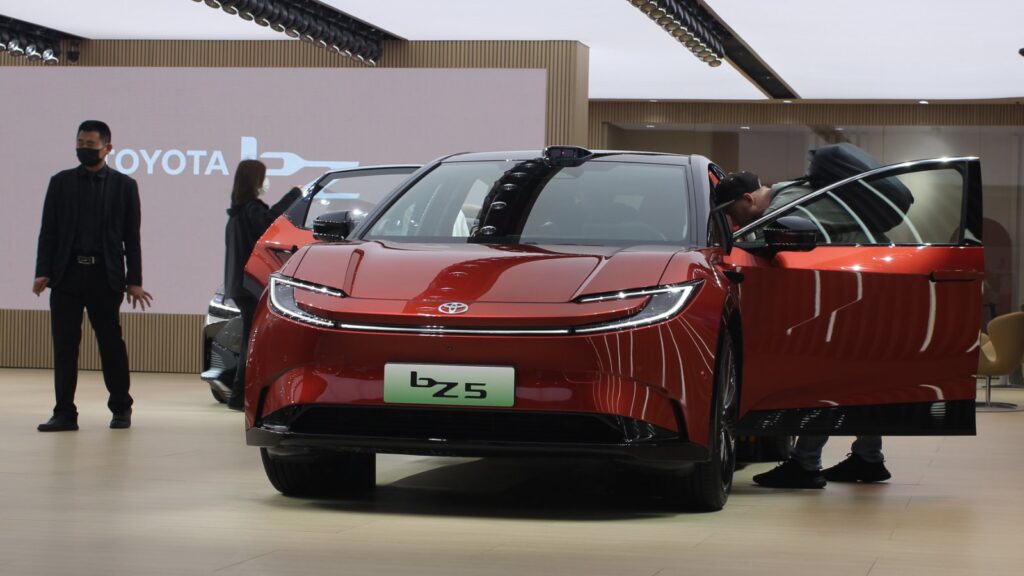 Front view of a red Toyota bZ5 with its doors open at the Shanghai Auto Show in April 2025.