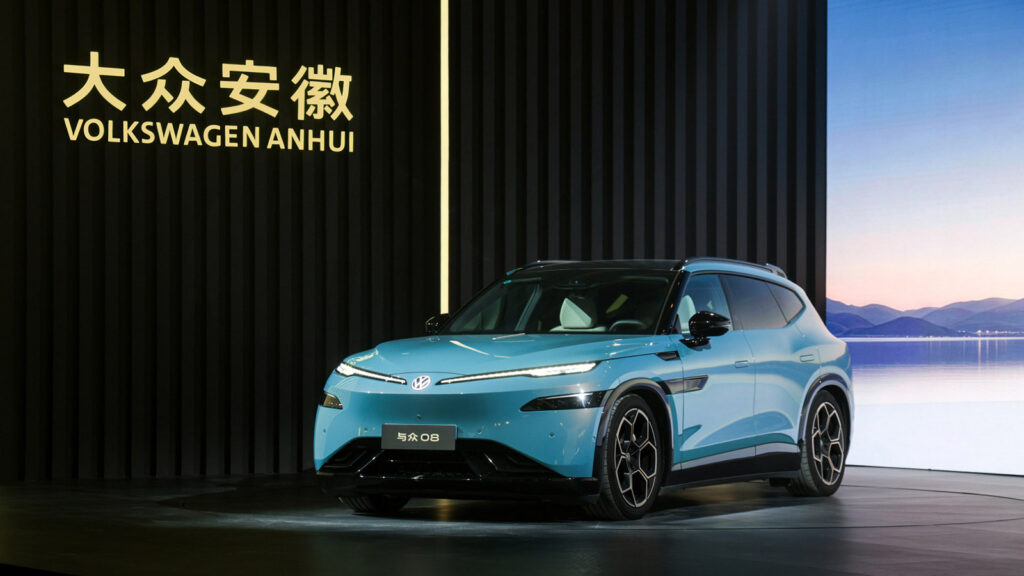VW Anhui refreshes ID. UNYX 08 SUV with lower prices just 5 months after launch Blue Volkswagen ID. UNYX 08 electric SUV displayed on stage, viewed from the front three-quarter angle.