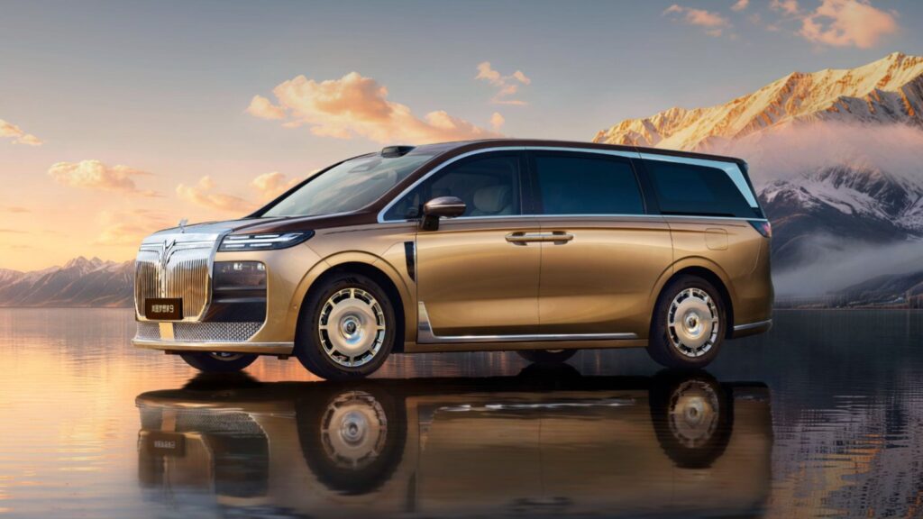 Gold and brown Voyah Dream 9 MPV viewed from the front and side against a snowy mountain backdrop.