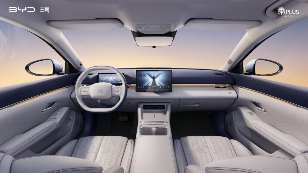 BYD shares interior images of third-gen Qin Plus as teaser campaign for key family sedan continues Dashboard view of the third-generation BYD Qin Plus interior, with a two-spoke steering wheel, digital driver display, floating central touchscreen, light ambient light strip and white seats with a dark blue upper dashboard