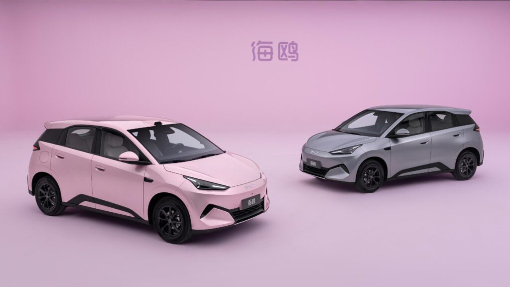 Pink and gray second-generation BYD Seagull electric hatchbacks shown from front three-quarter angles against a pink background.