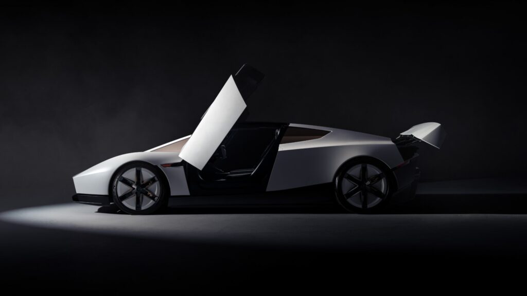 Tesla unveils redesigned Roadster, with Performance reservations available in China Side view of the redesigned Tesla Roadster with an upward-opening door and raised rear wing.