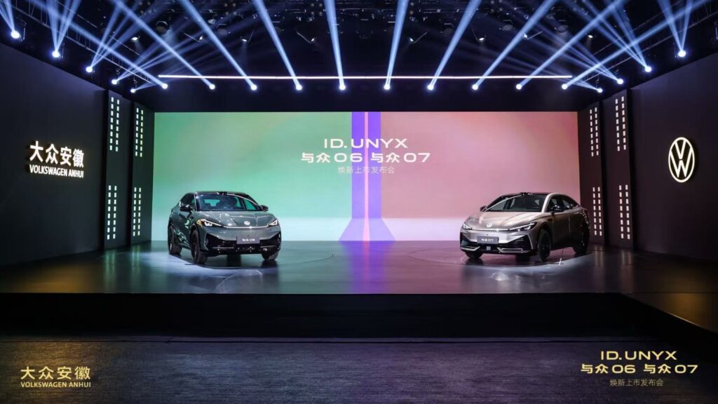 Volkswagen ID. UNYX 06 SUV and ID. UNYX 07 sedan displayed side by side on an illuminated launch stage.